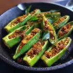 Irresistible Okra Stuffed With Spices – Authentic Telugu Recipe You’ll Love 6 okra stuffed with spices Telugu recipe in iron skillet